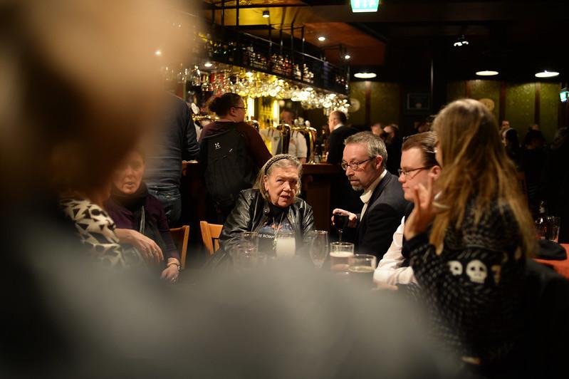 people talking at a bar